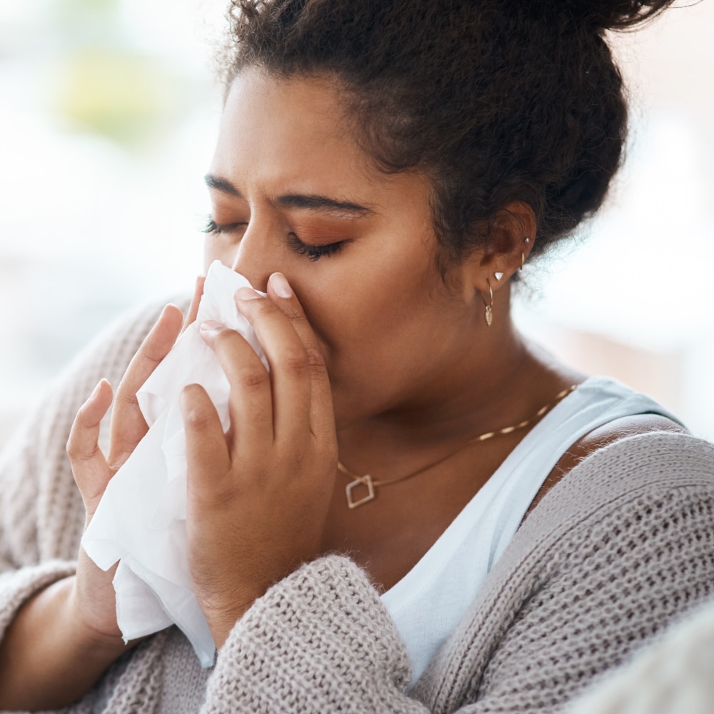 a woman blows her nose